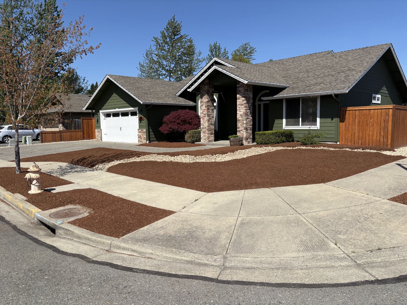 Corner lot after: fresh bark beds with clean edges