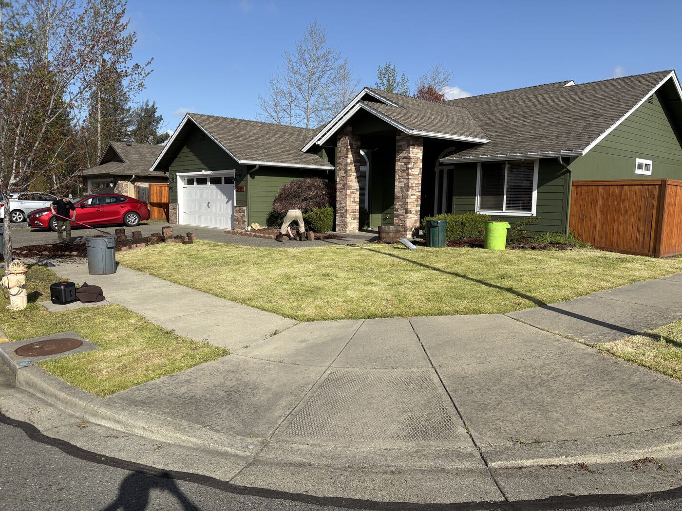 Corner lot before: patchy grass along the curb